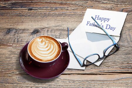 Cappucino with heart shape, letters, enveloppe and eyeglasses on Textured Black marble tableの写真素材