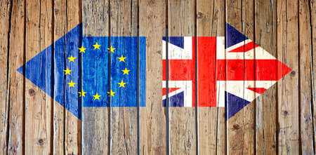 Two arrows with flags painting on wooden fence. Brexit conceptの写真素材