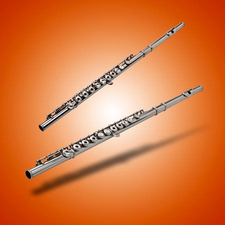 Floating Flute instrument with shadows on orange gradient backgroundの写真素材