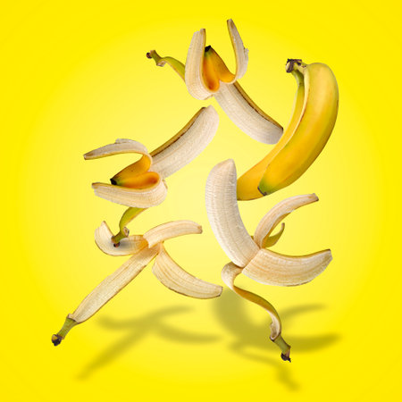 Floating set of bananas with shadows on yellow gradientの写真素材