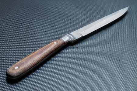 A table knife with a worn wooden handle