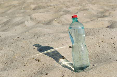 a bottle of water in the desertの写真素材