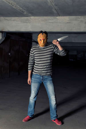 killer with a knife in a dark dungeonの写真素材