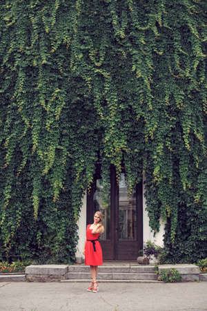 Blonde in bright red dressの写真素材