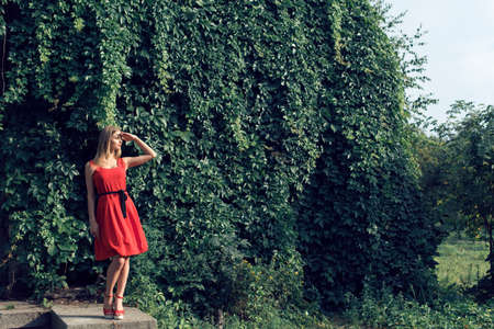 Blonde in bright red dressの写真素材