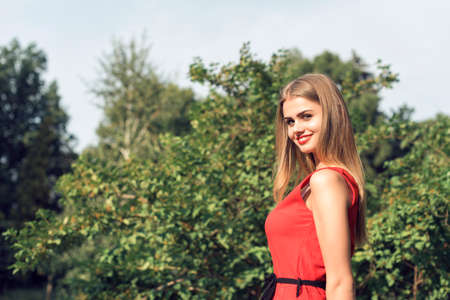 Blonde in bright red dressの写真素材