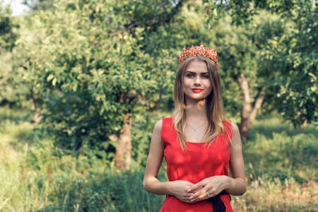 Blonde in bright red dressの写真素材