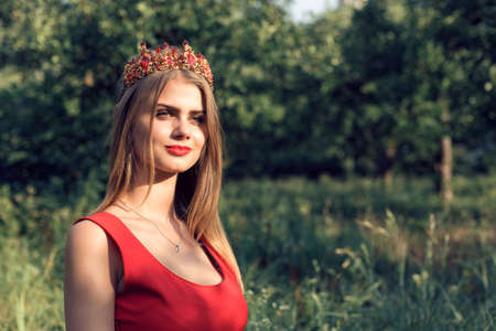 Blonde in bright red dressの写真素材