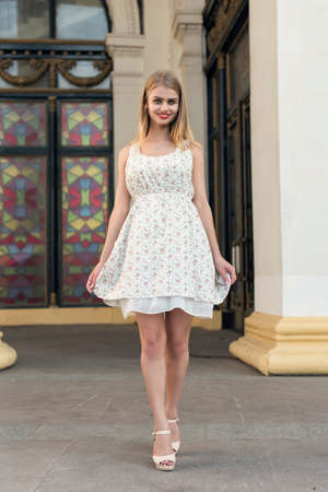 blonde in a summer white dressの写真素材