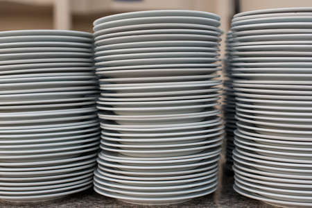 A lot of clean plates in the restaurantの写真素材