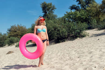 Young blond woman resting on the beachの写真素材
