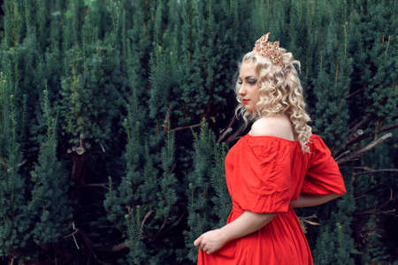 Blonde with curly hair in the parkの写真素材