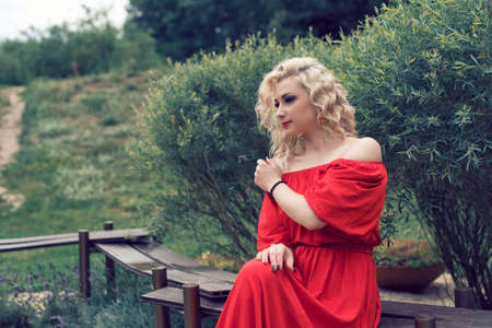 Blonde with curly hair in the parkの写真素材