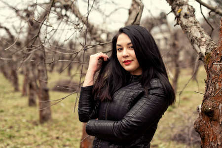 Plump girl on a cold spring walkの写真素材