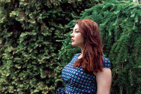 Plump girl on a botanical spring walk