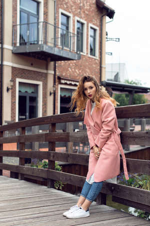 A girl is walking in the autumn in a European cityの写真素材