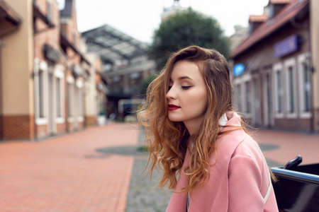 A girl is walking in the autumn in a European cityの写真素材