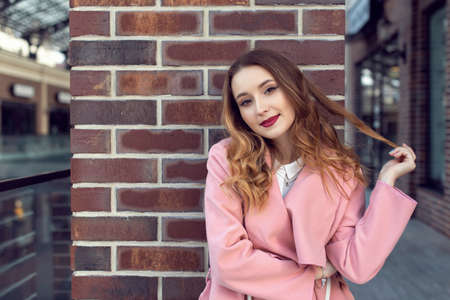 A girl is walking in the autumn in a European cityの写真素材