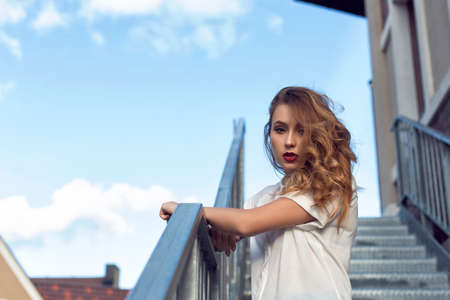 A girl is walking in the autumn in a European cityの写真素材