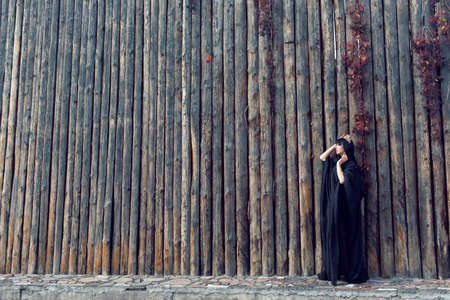 Young girl in a long black coatの写真素材