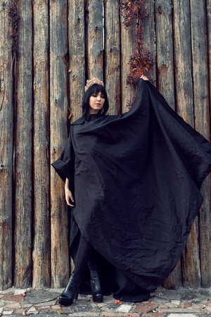 Young girl in a long black coatの写真素材