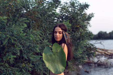 The girl in the forest near the riverの写真素材