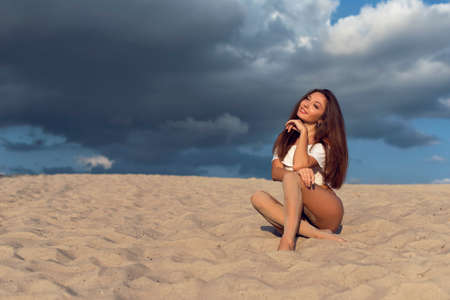 Walk with a brunette on the hot sandの写真素材