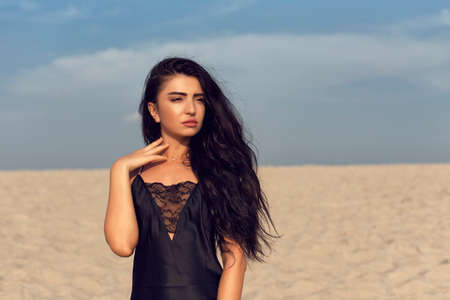 Beautiful brunette with long black curly hairの写真素材