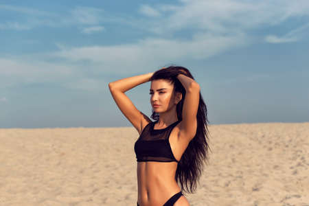 Beautiful brunette with long black curly hairの写真素材