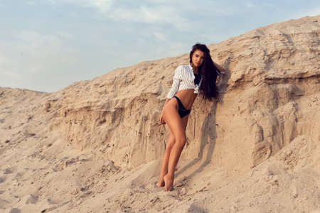 Beautiful brunette with long black curly hairの写真素材