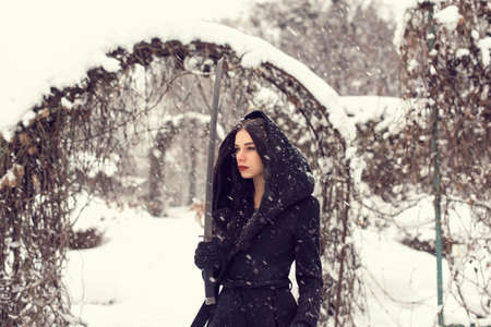 In the park with a girl in snowy weatherの写真素材