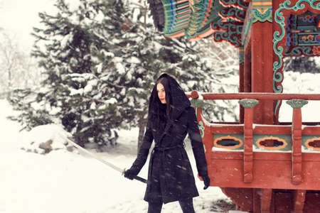 In the park with a girl in snowy weatherの写真素材