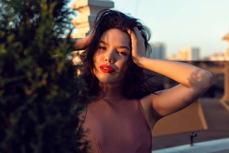Stylish young brunette in a fashionable studio