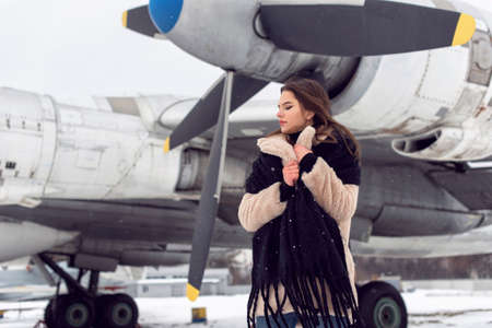 Tourist girl in winter at the airportの写真素材