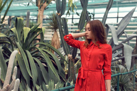 Walk with a young girl in the summer botanical gardenの写真素材