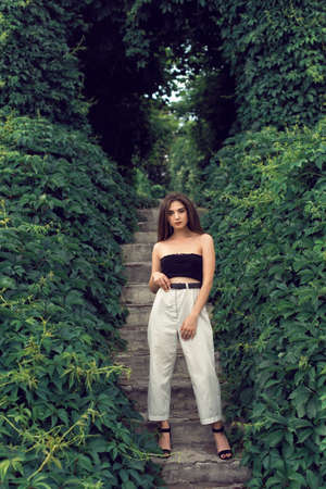 Young brunette in stylish modern clothes