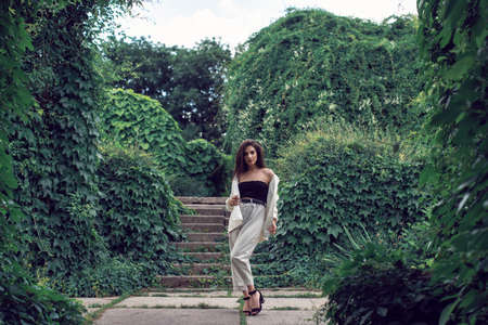 Young brunette in stylish modern clothes