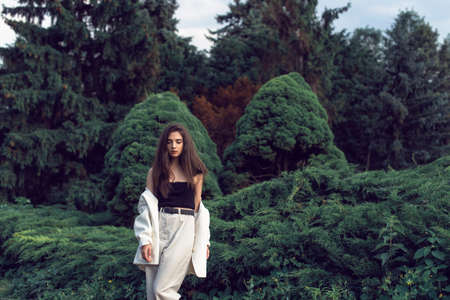 Young brunette in stylish modern clothesの写真素材