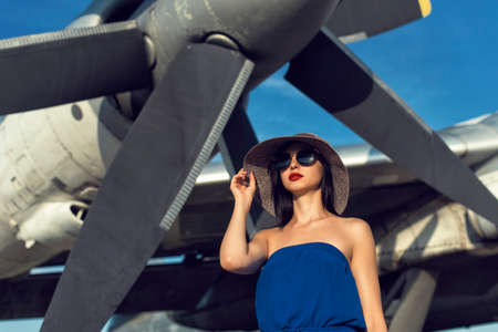 Brunette in a dress at the old airportの写真素材