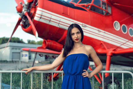 Brunette in a dress at the old airportの写真素材