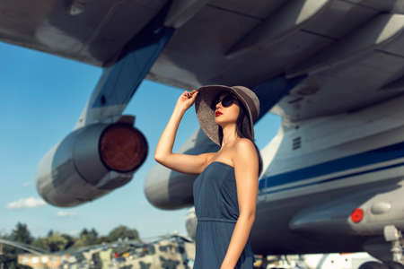 Brunette in a dress at the old airportの写真素材