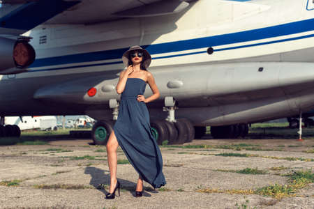 Brunette in a dress at the old airportの写真素材
