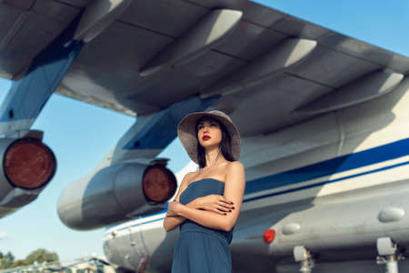 Brunette in a dress at the old airportの写真素材