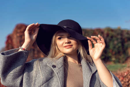 Autumn walk in the park with a cute blondeの写真素材