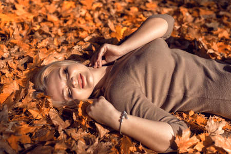 Autumn walk in the park with a cute blonde