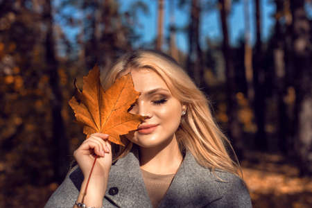 Autumn walk in the park with a cute blonde