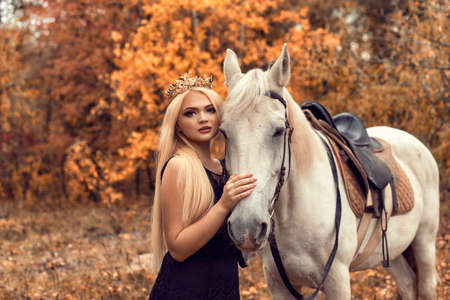 Autumn photo session in the park with a horseの写真素材