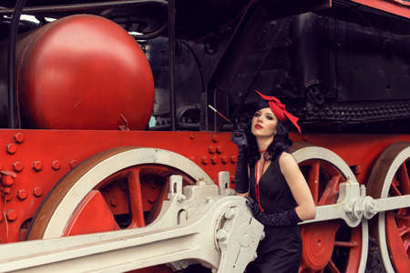 Young girl at the retro train stationの写真素材