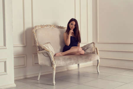 Young girl in a blue dress in the studioの写真素材