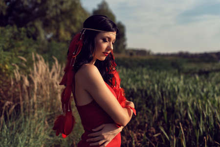 Young girl in red by the river